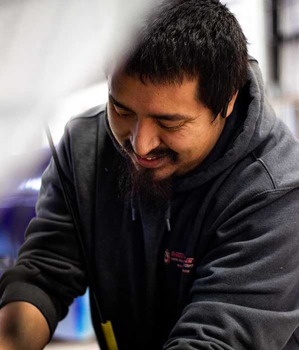 Mid-Valley Auto Body & Service Center Mechanic working underneath the hood of car