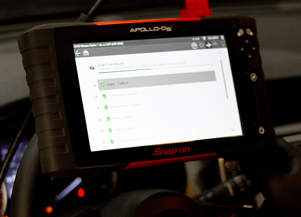 Vehicle diagnosis scanner on steering wheel of car